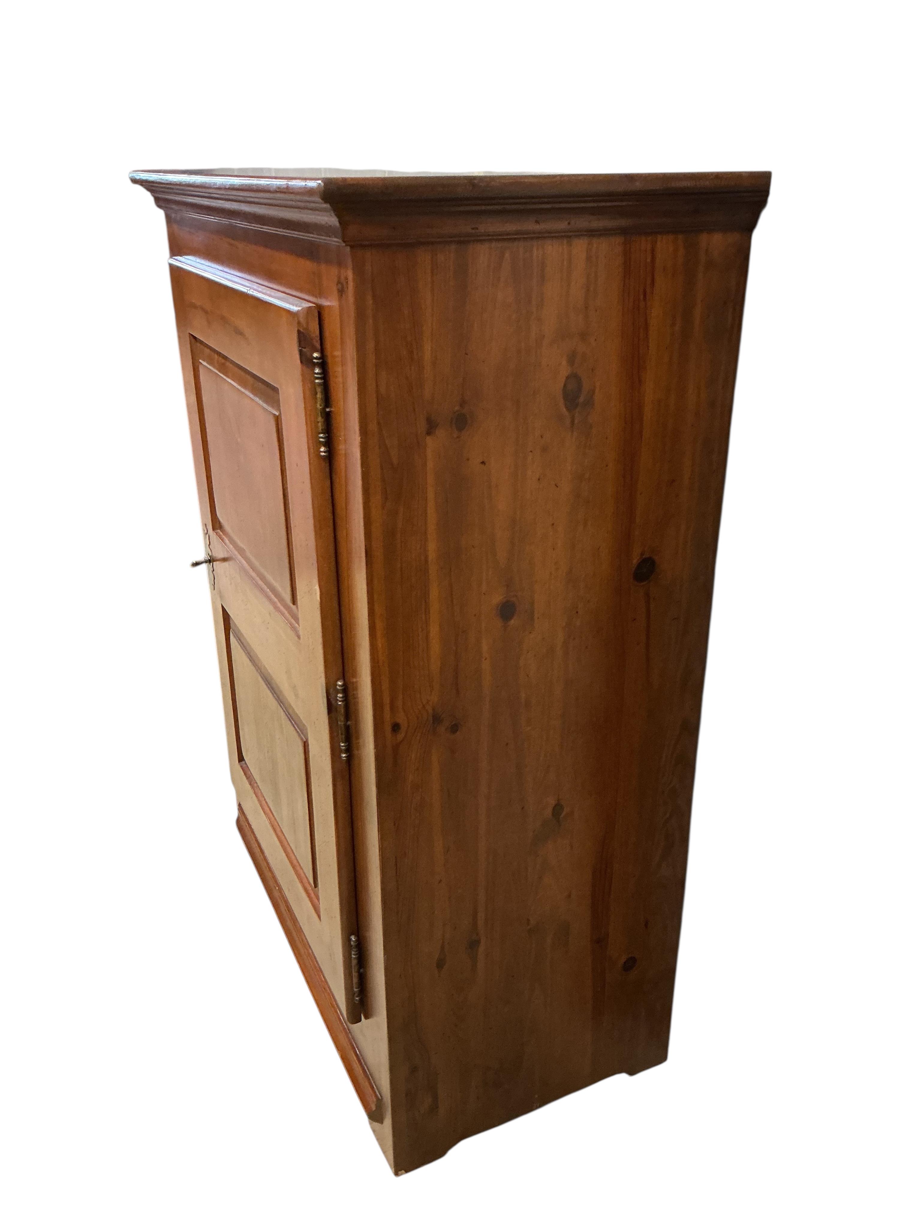 A reproduction 18th century style French pine side cabinet, width 104cm, depth 55cm, height 140cm